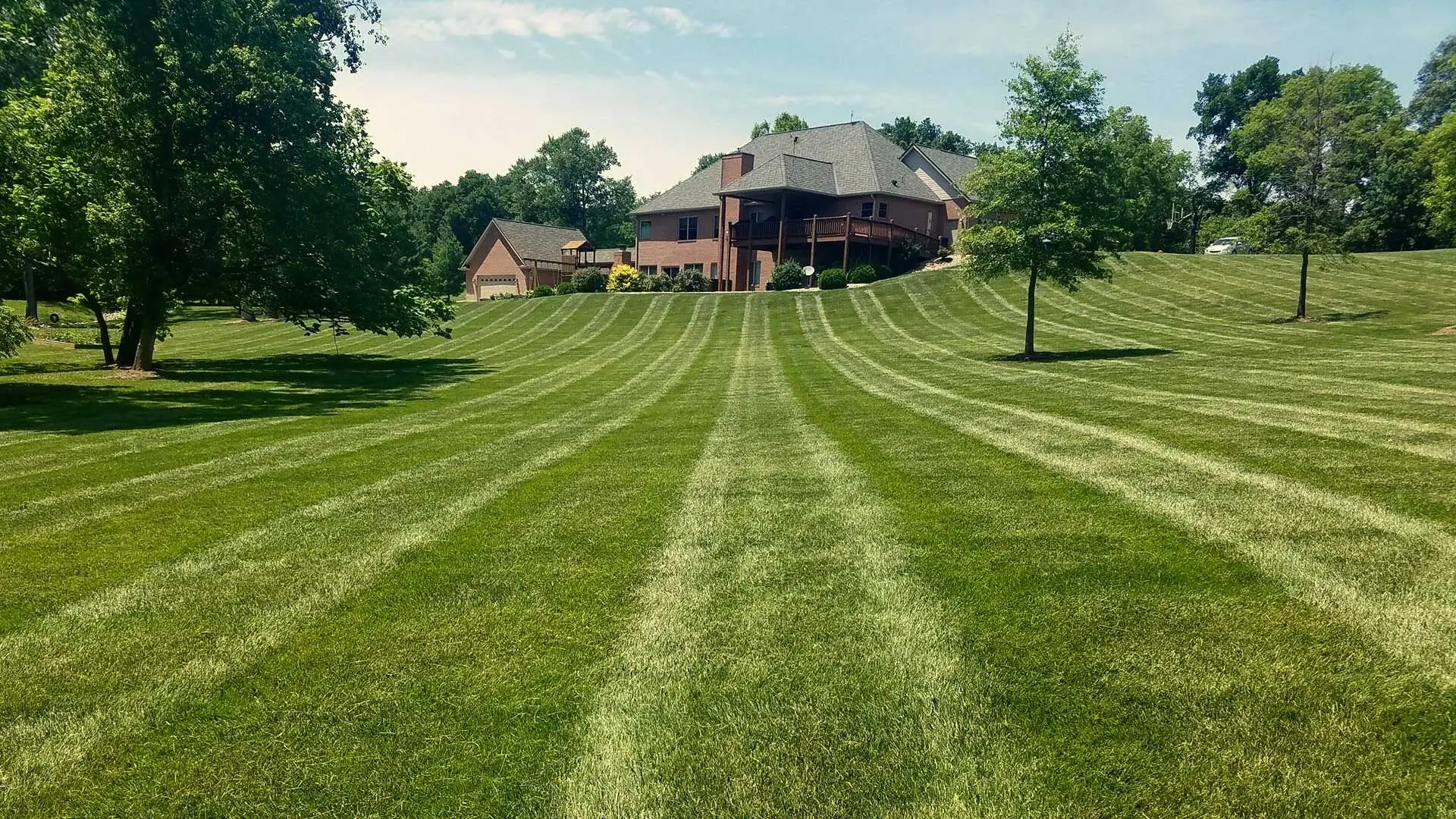 Professional mowing services at a home in Alton.