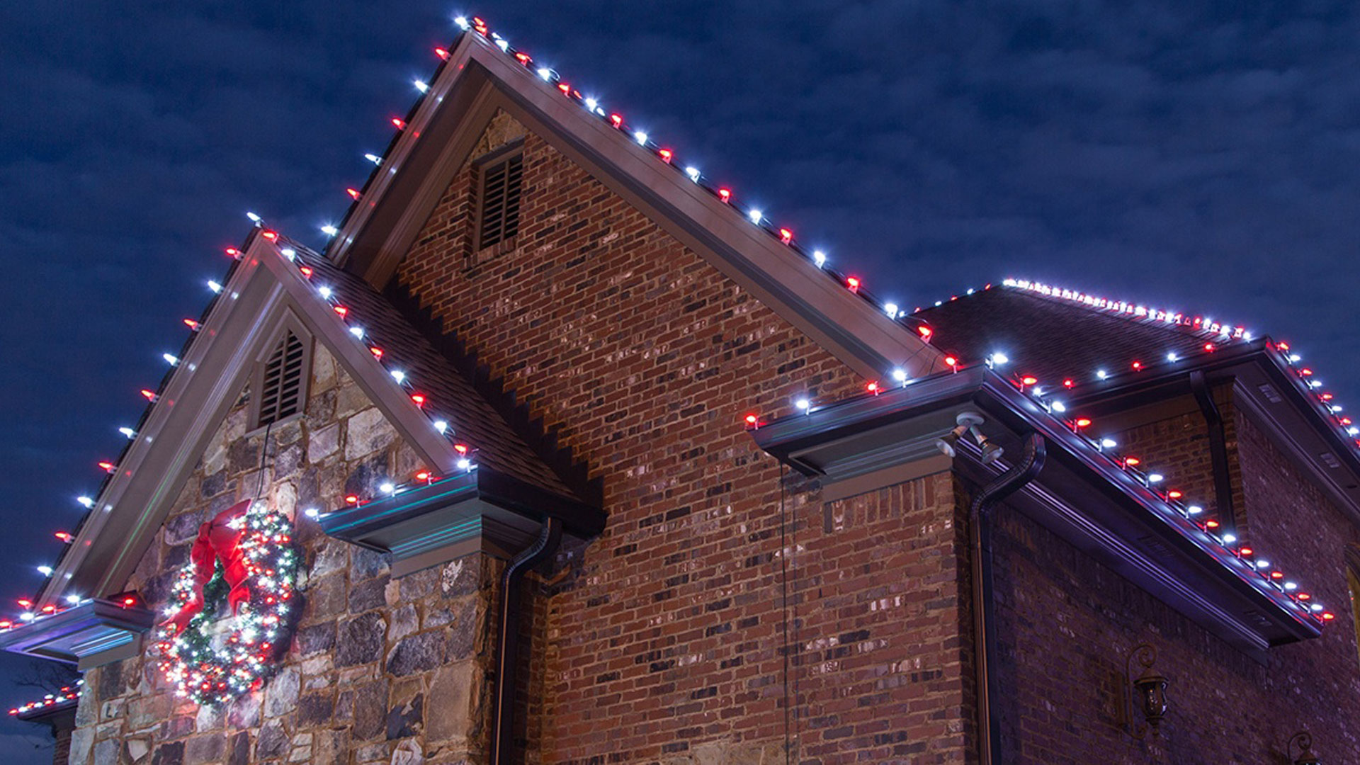 White holiday lights installed by Element Turf & Outdoor Solutions, LLC for a commercial client in Alton