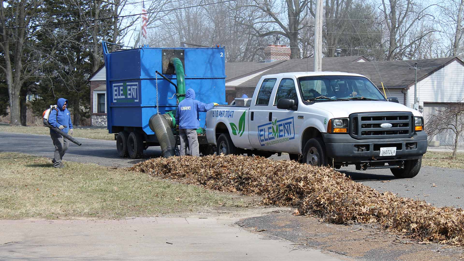 Element Turf & Outdoor Solutions, LLC work crew removing fall leaves from a yard in Alton, IL.