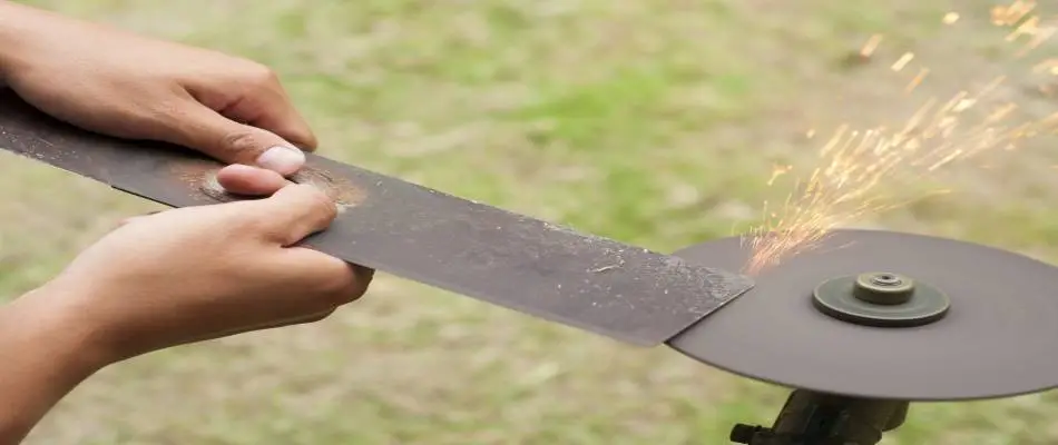 picture of a lawn mower blade being sharpened