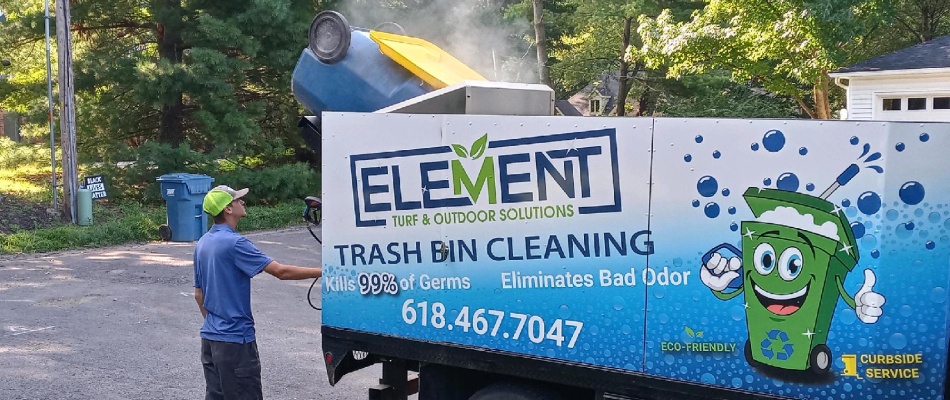 Trash bin cleaning truck servicing a bin in Hartford, IL.