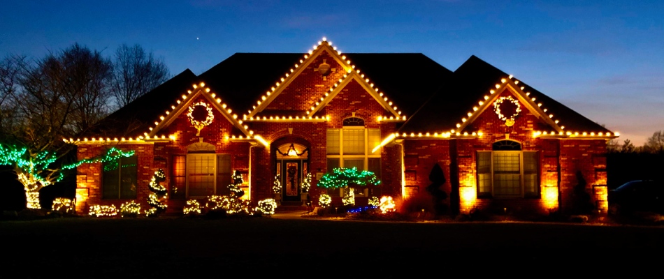 Holiday lighting hung on full landscape and house in Rosewood, Heights, IL.