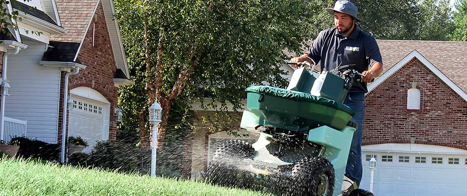 Element professional applying fertilizer to lawn in Edwardsville, IL.